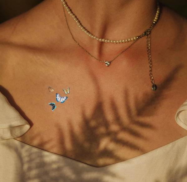 A  vitamin patch featuring four butterflies near collarbone.